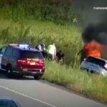 Officer and bystanders rush to pull passenger from burning carOfficer and bystanders rush to pull passenger from burning car 