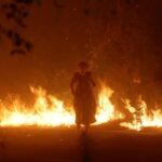 Video captures moment woman walks through wildfire flamesVideo captures moment woman walks through wildfire flames 